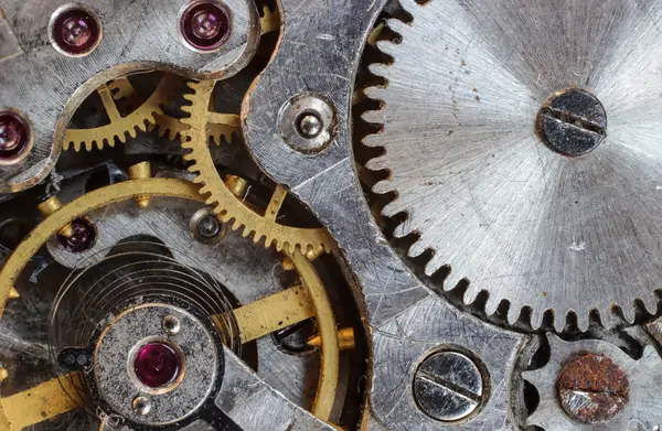 a close up of the gears of a clock.